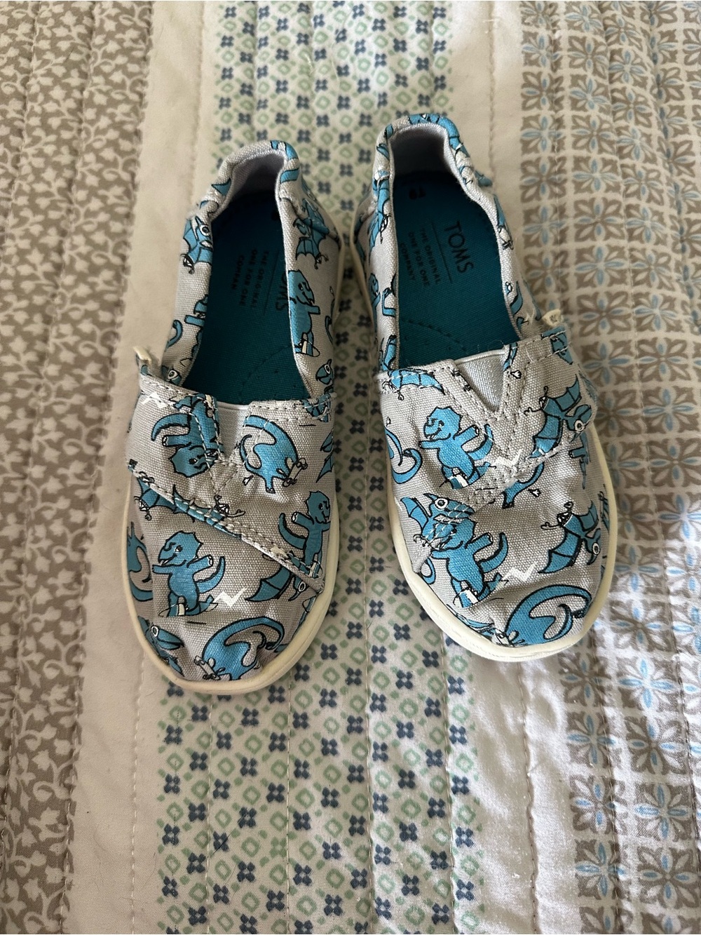 Toms Kids Light Gray Slip-On Sneakers with Blue Dinosaur Print